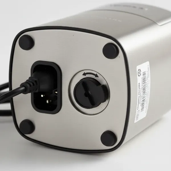 External fuse holder on electric coffee grinder near power cord inlet.