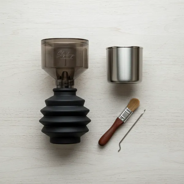 A display of various components in a single dose coffee grinder conversion kit, including hopper, bellows, and cup.